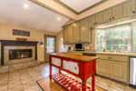 Fireplace and breakfast nook in Kitchen at 1138 Woodley Road in historic Cloverdale, Montgomery, AL. I Shoot Houses...Professional photos and tour by Sherry Watkins at Go2REasssistant.com