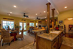 Terrace level living area with fireplace and kitchen at 1270 North Ridge in The Ridge, Lake Martin waterfront homes for sale. Photos by Go2REassistant.com