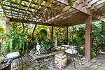 Ivy covered pergola outside Greatroom at 2060 South Hull Street in historic Cloverdale, Montgomery, AL. Professional photos and tour by Go2REasssistant.com