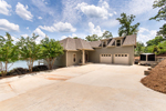 Street side with 2-car garage and level RV/trailer pad at 834 Long Branch in The Harbor, Dadeville, AL-Lake Martin AL Waterfront homes for sale. Professional photos and tour by Go2REasssistant.com