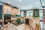 Open kitchen with Gathering Room and Breakfast Nook at 375 Windy Wood in Windermere West, AL. Professional photos and tour by Go2REasssistant.com