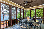 Outdoor dining overlooking the lake at 421 Windy Wood, Windermere West, Lake Martin, Alexander City, AL. Professional photography and tour by Sherry Watkins, Go2REassistant.com