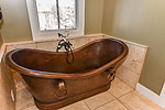 Stunning copper soaking tub in Master Bath at 49 Avenue of the Waters, Lucas Point at The Waters, Pike Road, AL. Professional photos and tour by Go2REasssistant.com