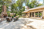 NEW outdoor living area with kitchen, bar and fireplace view at 8100 Wyndridge Drive, Montgomery, AL. Professional photos and tour by Go2REasssistant.com