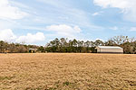 Another front pasture with shed at 984 Muskgokee Trail, Tallassee, AL. Professional photos and tour by Go2REasssistant.com