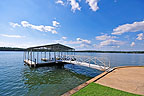 Floating covered boathouse for year-round easy access to the lake at 188 Mountain View Lane, Still Waters Golf Community, Lake Martin - Alexander City, AL. Professional photos and tour by Go2REasssistant.com
