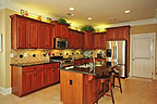Open kitchen with breakfast bar island at 8207 Stonewall Ct in Sturbridge, Montgomery, AL. Professional photos and tour by Go2REasssistant.com