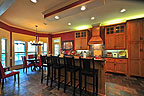 Bright open kitchen with breakfast bar and bay windowed breakfast nook overlooking the lake at 421 Windy Wood, Windermere West, Lake Martin, Alexander City, AL. Professional photography and tour by Sherry Watkins, Go2REassistant.com